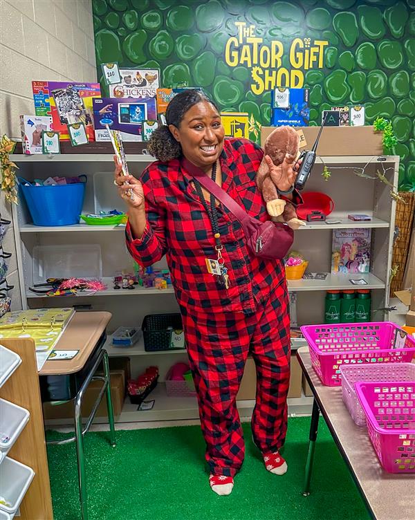 principal in red pajamas in library